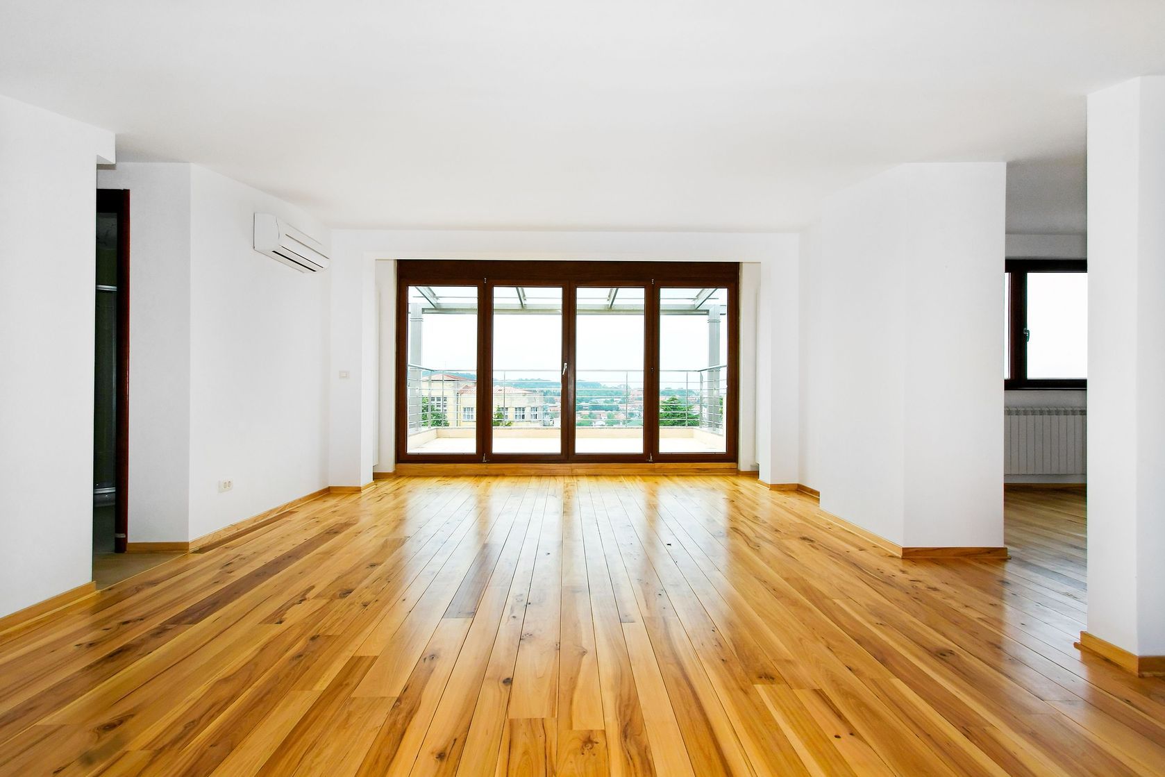 Bright room with installed natural hardwood flooring